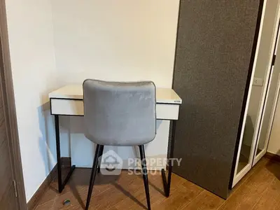 Cozy study nook with modern desk and chair in a compact space.