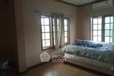 Cozy bedroom with large windows and natural light