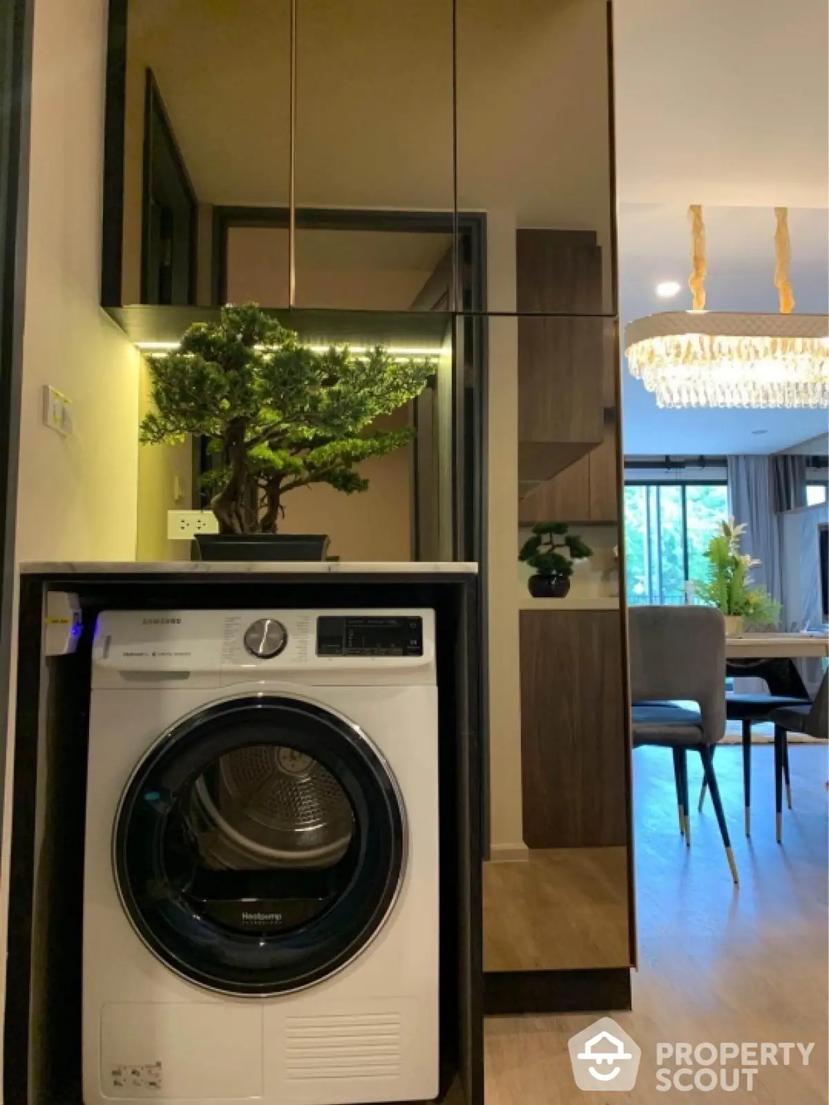 Modern apartment interior with washing machine and elegant dining area