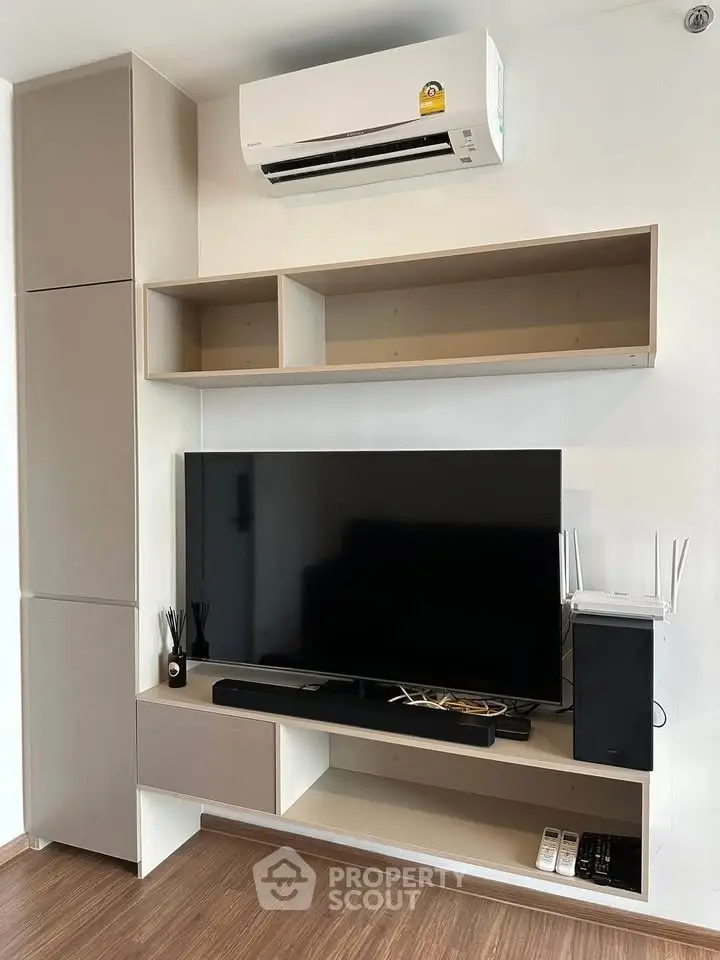 Modern living room with sleek TV setup and air conditioning
