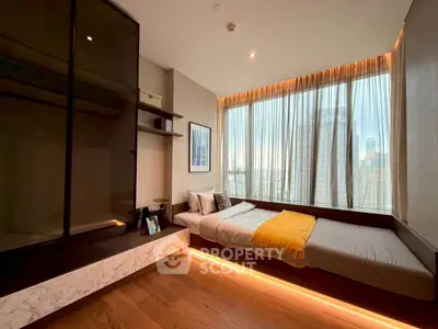 Modern bedroom with large windows and city view, featuring sleek design and warm lighting.