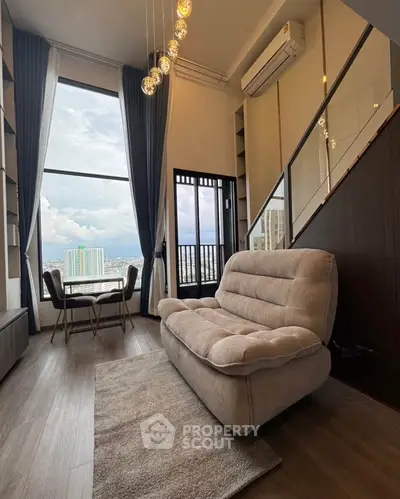 Luxurious living room with high ceilings and stunning city view, featuring modern furniture and elegant lighting.