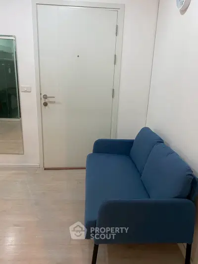 Cozy interior with blue sofa and white door, perfect for modern living spaces.