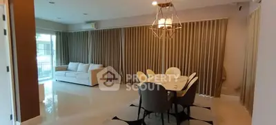 Spacious living room with elegant dining area and modern lighting