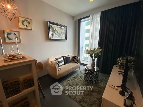 Stylish living room with cozy sofa, modern decor, and large window for natural light.