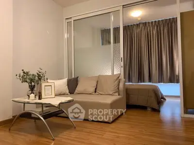 Modern studio apartment with cozy living area and elegant bedroom