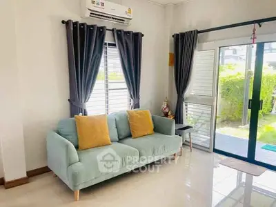 Charming living room with cozy sofa and garden view, perfect for relaxation.