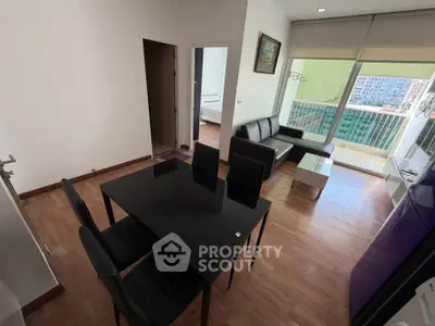 Modern living room with dining area and balcony view in urban apartment