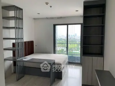 Modern bedroom with large window offering stunning city view and sleek built-in shelves.