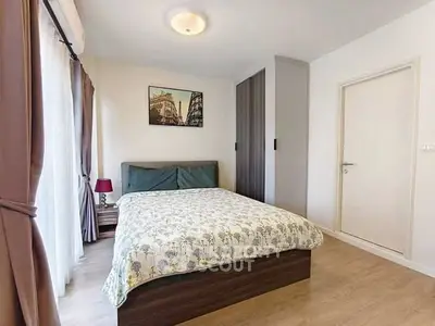 Cozy bedroom with modern decor and ample natural light