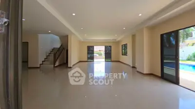 Spacious open-plan living room with pool view and modern design