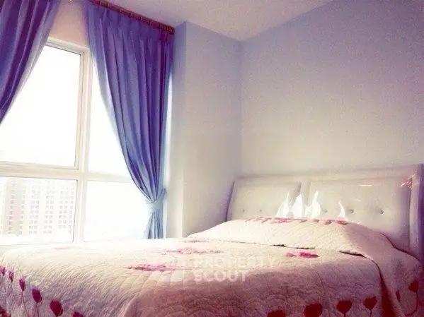 Cozy bedroom with large window and elegant curtains, perfect for relaxation.