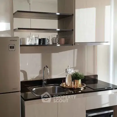 Modern kitchen with sleek cabinetry, stainless steel appliances, and elegant open shelving.