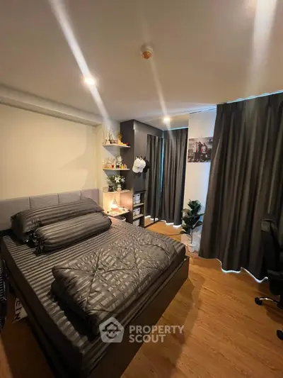Cozy modern bedroom with stylish decor and ample natural light