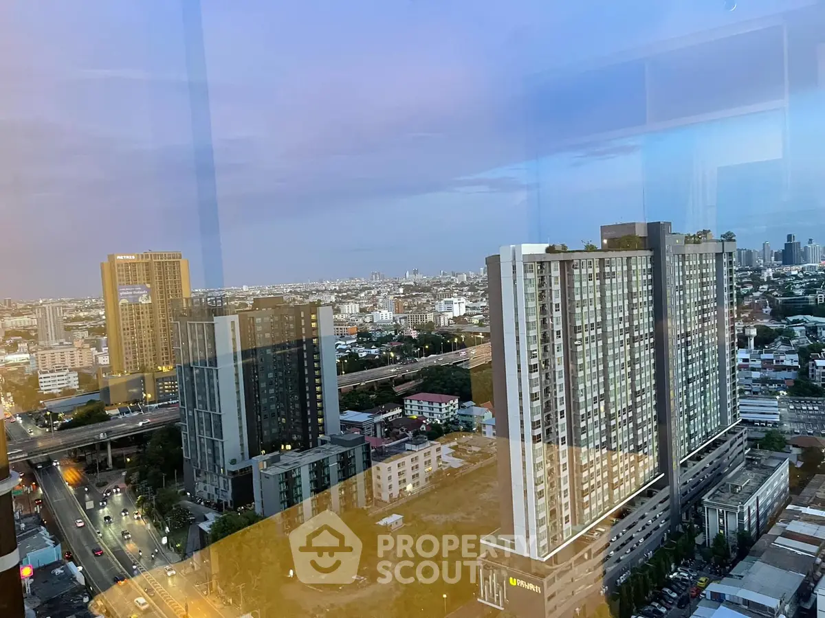 Stunning cityscape view from high-rise building at dusk, showcasing urban skyline and modern architecture.