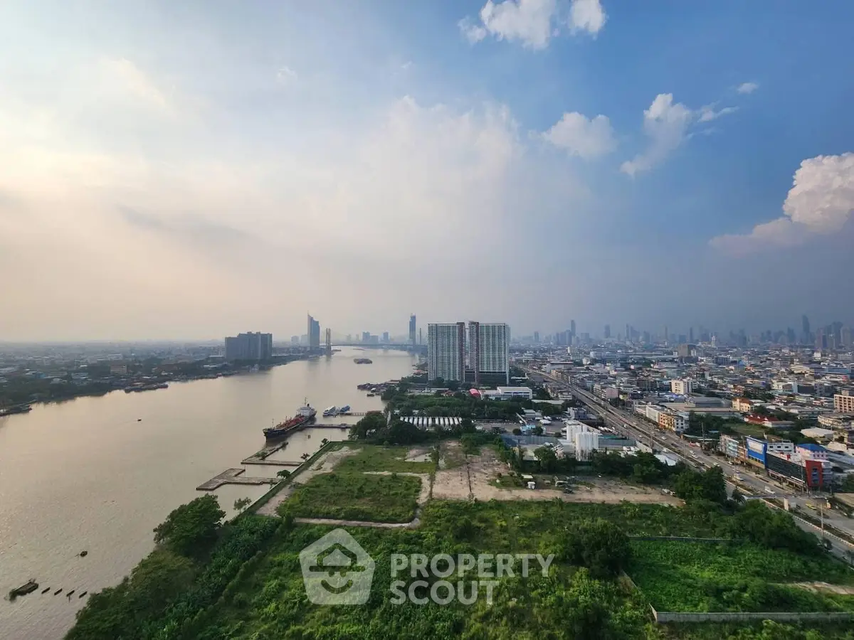 Stunning riverfront cityscape with high-rise buildings and lush greenery, perfect for urban living.
