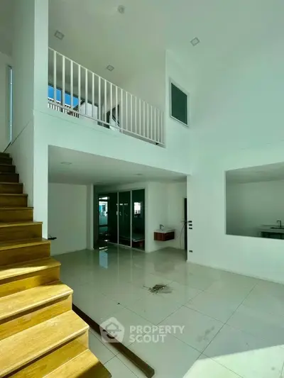 Spacious modern interior with high ceilings and elegant staircase