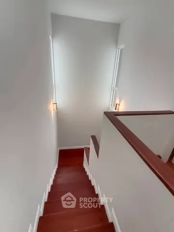 Elegant wooden staircase with modern lighting in a stylish home