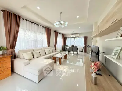 Spacious and elegant living room with modern decor and ample natural light.