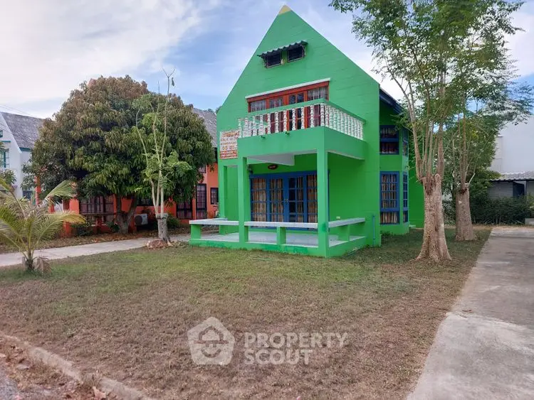 Charming green house with balcony and spacious front yard
