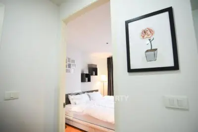 Cozy bedroom with modern decor and soft lighting, perfect for relaxation.