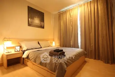 Cozy bedroom with warm lighting and elegant decor, featuring a comfortable bed and stylish curtains.