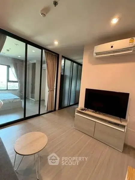 Modern living room with glass partition and air conditioning in a stylish apartment.