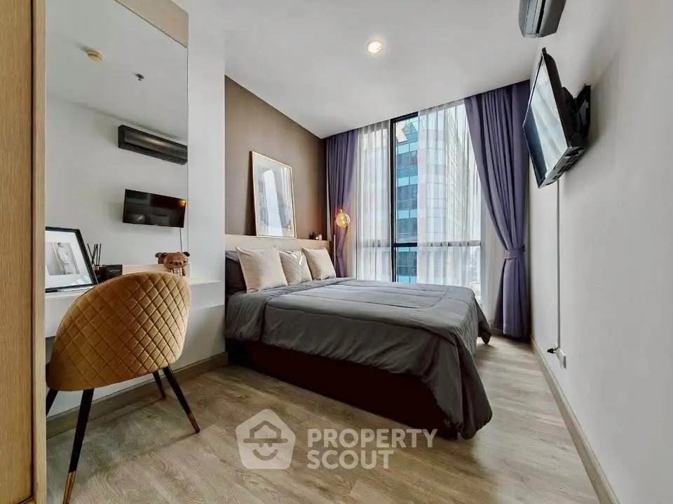 Modern bedroom with city view, stylish decor, and cozy ambiance in urban apartment.