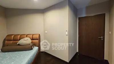 Cozy bedroom with modern decor and plush bedding in a stylish apartment.
