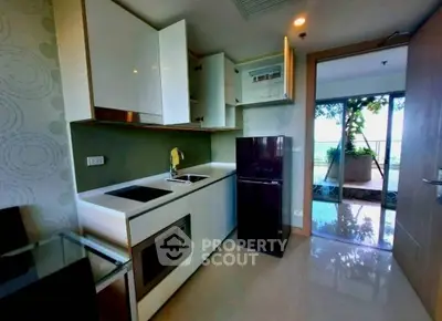 Modern kitchen with sleek appliances and open balcony view