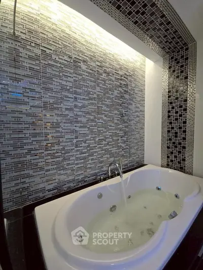 Luxurious bathroom with modern jacuzzi tub and stylish mosaic tiles