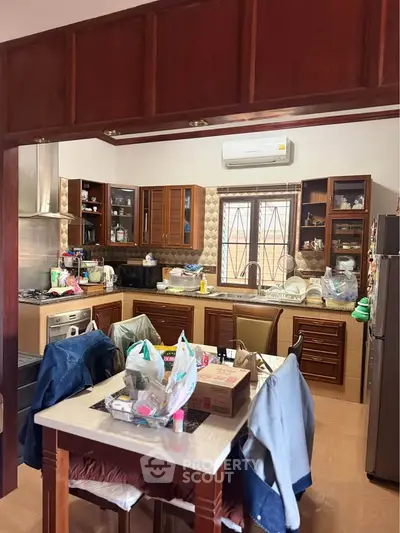 Spacious kitchen with modern appliances and wooden cabinetry, perfect for culinary enthusiasts.