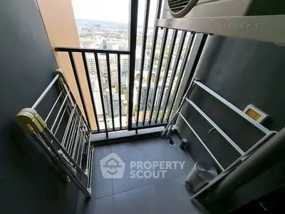 High-rise balcony with city view and drying racks, perfect for urban living.