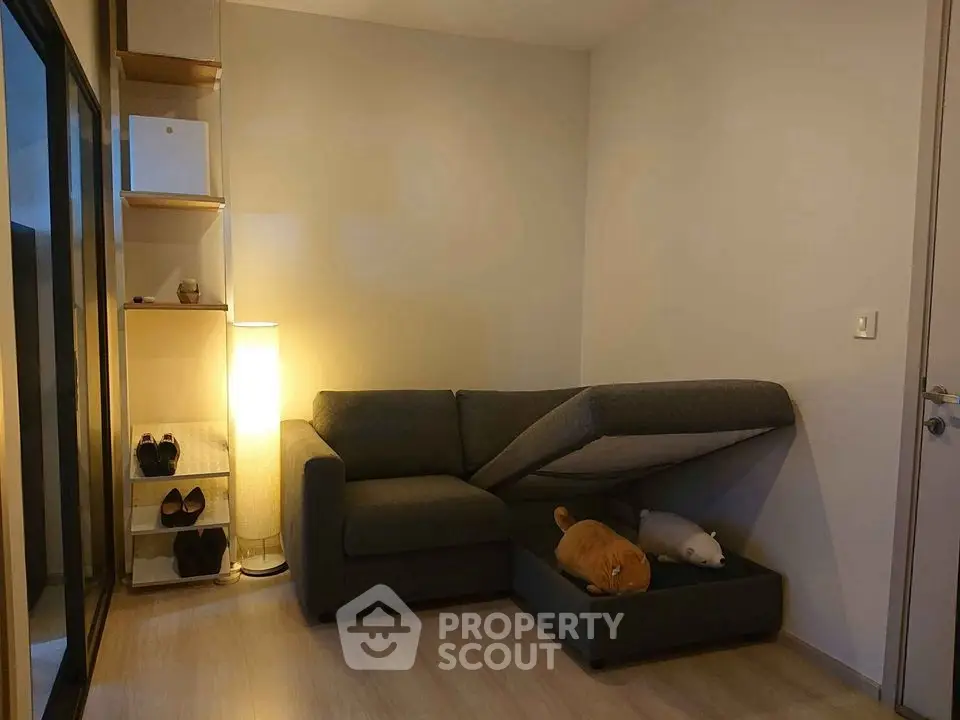 Cozy living room with modern sofa and stylish shelving, perfect for urban living.