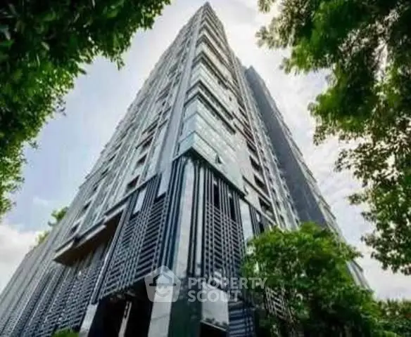 Stunning modern high-rise building with sleek architecture and lush greenery.