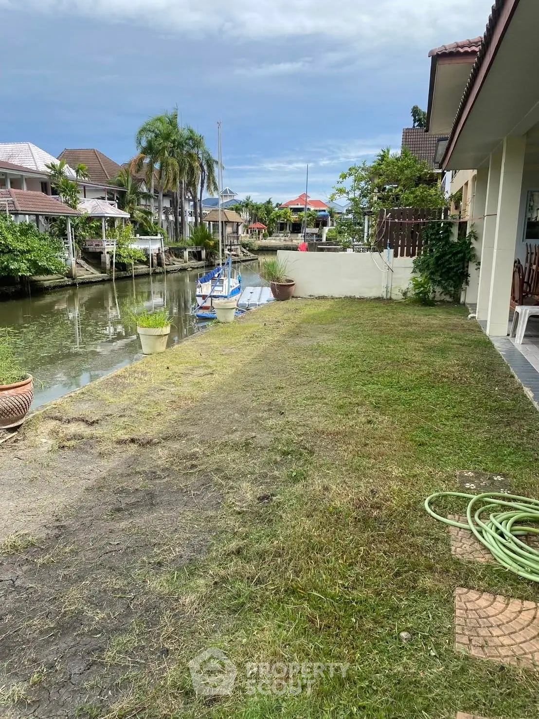 Charming waterfront property with lush garden and canal view, perfect for serene living.