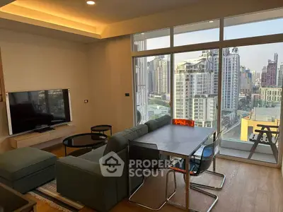 Modern living room with stunning city view and sleek furniture in high-rise apartment.