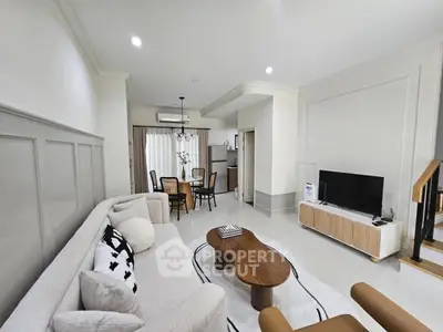Spacious modern living room with elegant decor and open dining area