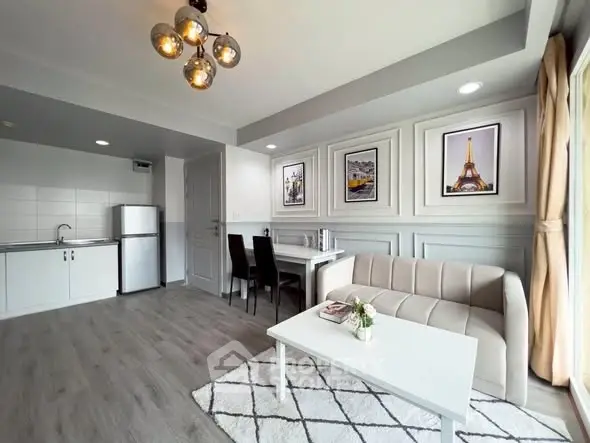 Modern living room with open kitchen, stylish decor, and ample natural light in a contemporary apartment.