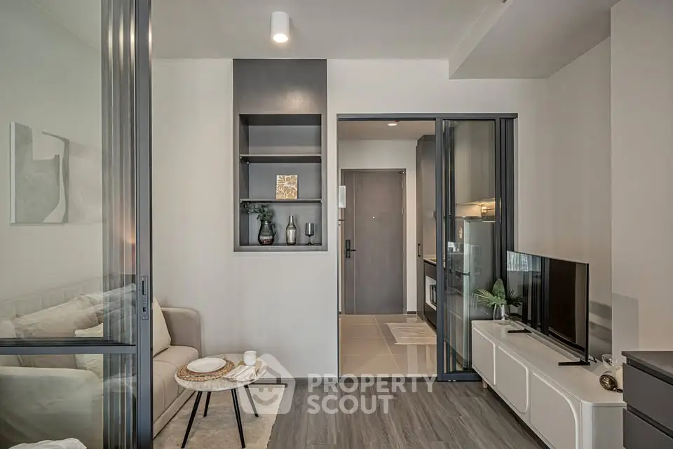Modern living room with sleek design and open layout, featuring stylish furniture and decor.