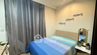 Cozy bedroom with modern decor and blue bedding in a stylish apartment.