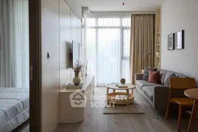 Modern living room with stylish decor and natural light in a cozy apartment setting.