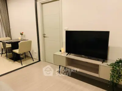 Modern living room with sleek TV stand and dining area, perfect for contemporary living.