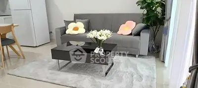 Modern living room with stylish gray sofa, chic coffee table, and elegant decor accents.