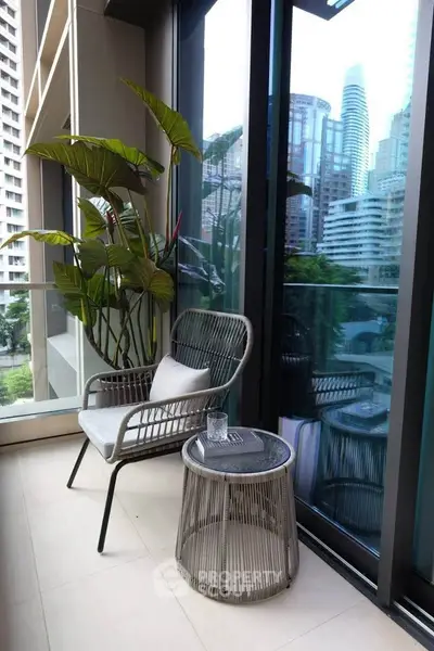 Chic urban balcony with modern seating and cityscape view