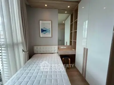Modern bedroom with sleek design, built-in storage, and natural light.