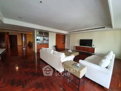 Spacious living room with elegant wooden flooring and modern furniture