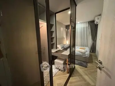 Modern bedroom with mirrored closet and cozy lighting in stylish apartment