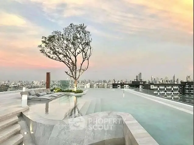 Luxurious rooftop infinity pool with stunning city skyline view at sunset.