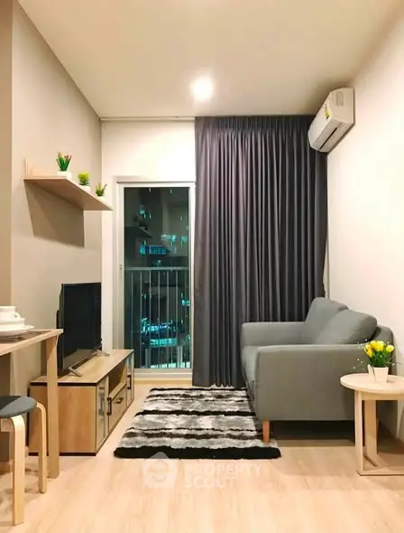 Modern living room with cozy sofa, stylish decor, and city view from balcony.
